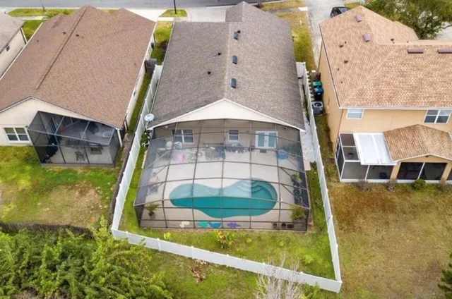 an aerial view of a house with swimming pool