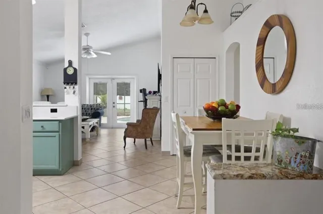a dining room with furniture and a mirror