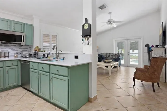 a kitchen with cabinets and chairs