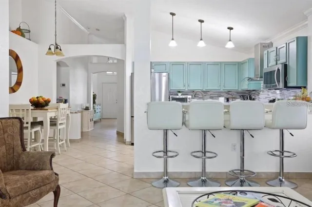 a large kitchen with a table and chairs