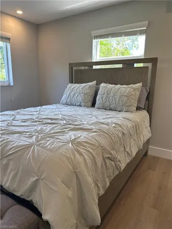 a bed sitting in a bedroom next to a window