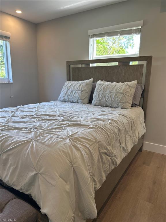 780 10th Avenue South, Unit 5 Naples, FL 34102 - Photo 11 of 27 a bed sitting in a bedroom next to a window