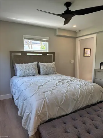 a bedroom with a bed and a lamp on the dresser