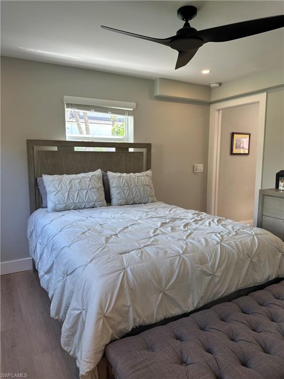 780 10th Avenue South, Unit 5 Naples, FL 34102 - Photo 13 of 27 a bedroom with a bed and a lamp on the dresser