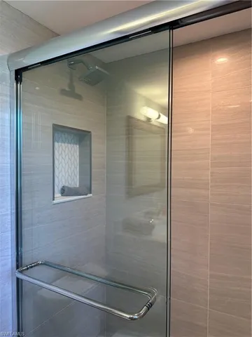 a bathroom with a glass shower door