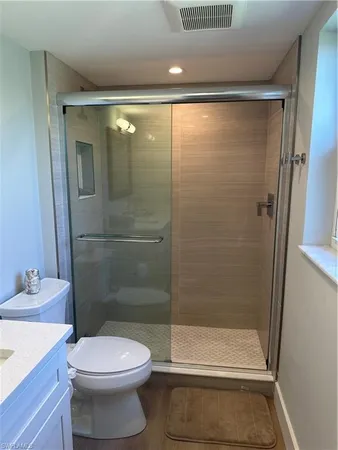 a bathroom with a shower and a toilet