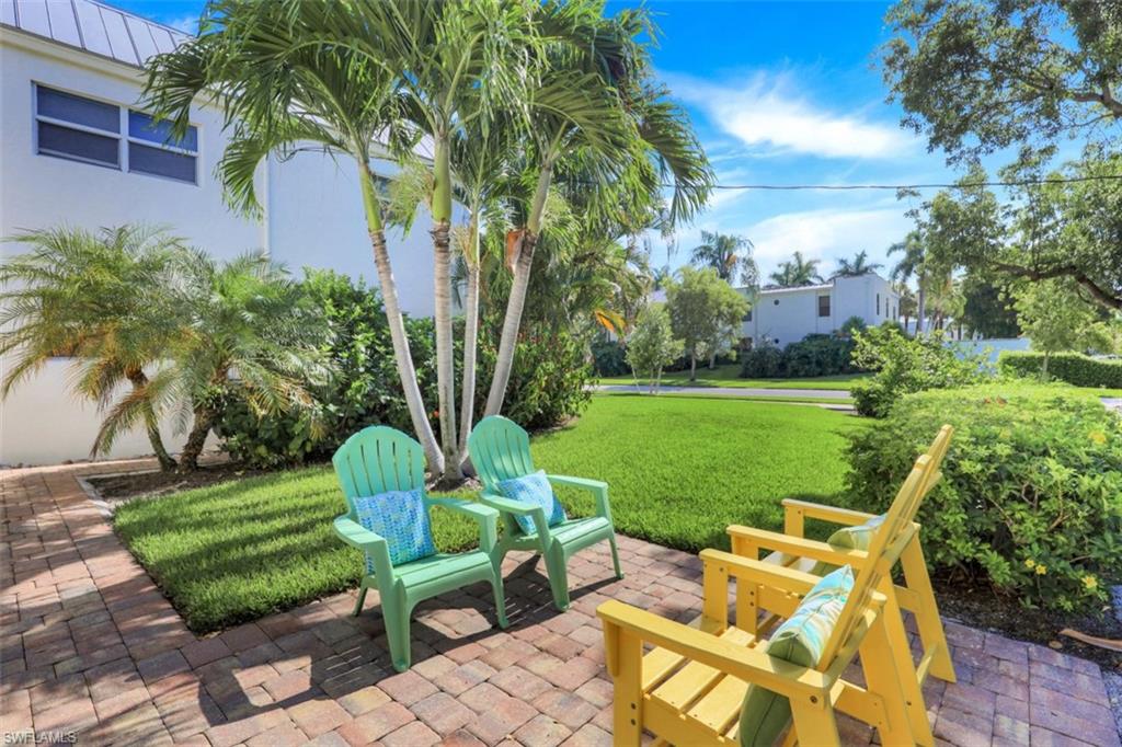 780 10th Avenue South, Unit 5 Naples, FL 34102 - Photo 25 of 27 a view of yard with seating area and trees around