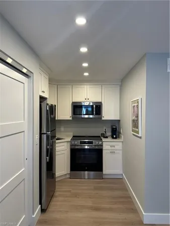 a kitchen with a stove a refrigerator and a sink