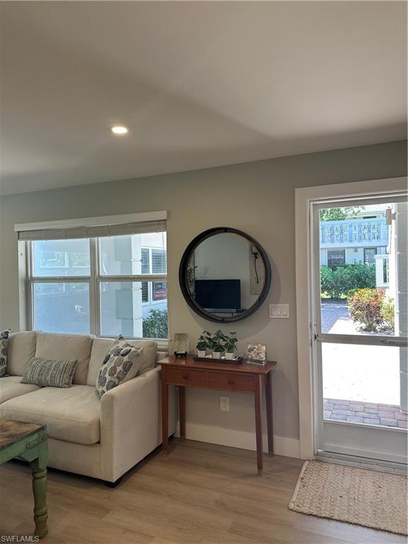 780 10th Avenue South, Unit 5 Naples, FL 34102 - Photo 6 of 27 a living room with a couch and a large window