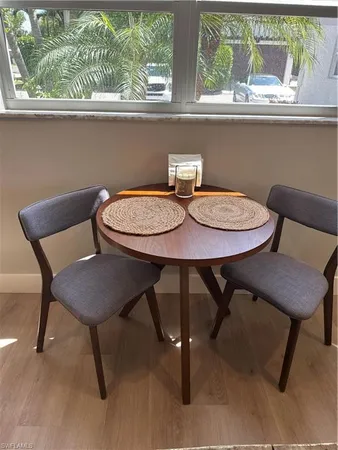 a view of a dining room with furniture window and wooden floor