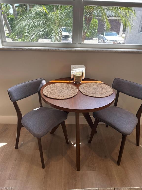 780 10th Avenue South, Unit 5 Naples, FL 34102 - Photo 10 of 27 a view of a dining room with furniture window and wooden floor