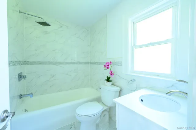 a bathroom with a sink toilet and bathtub