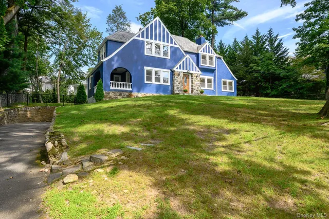 a front view of house with yard and green space