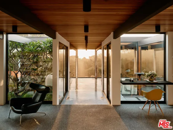 a building outdoor space with patio furniture and potted plants