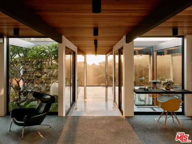 a building outdoor space with patio furniture and potted plants