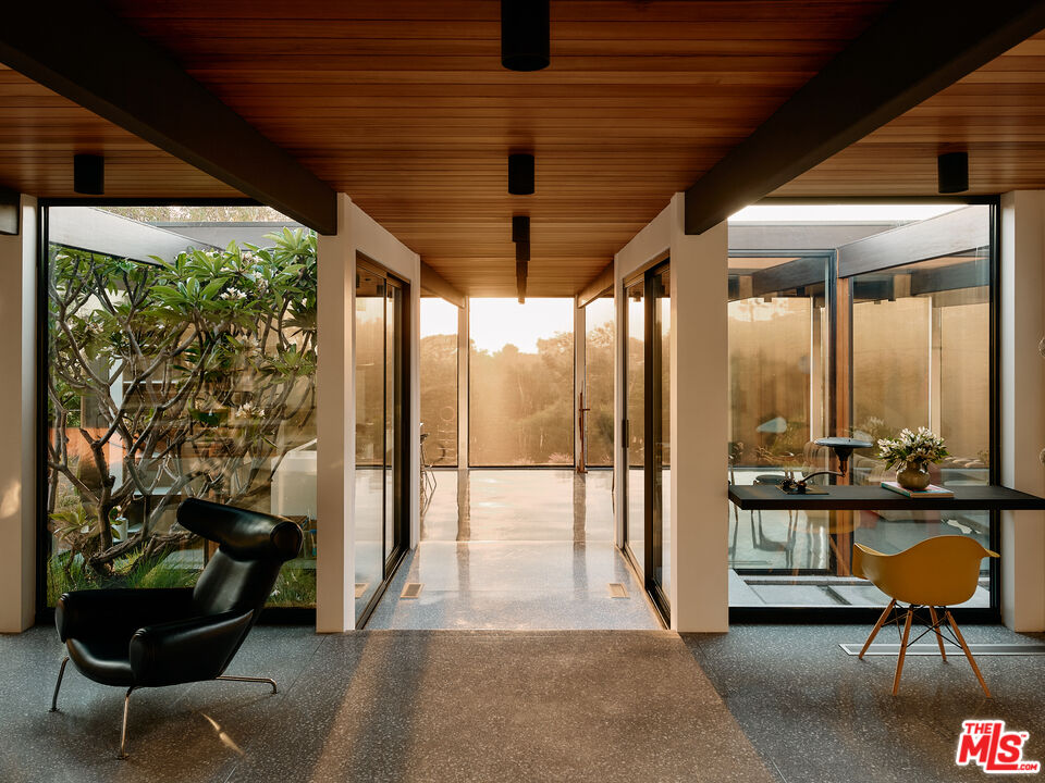 a building outdoor space with patio furniture and potted plants