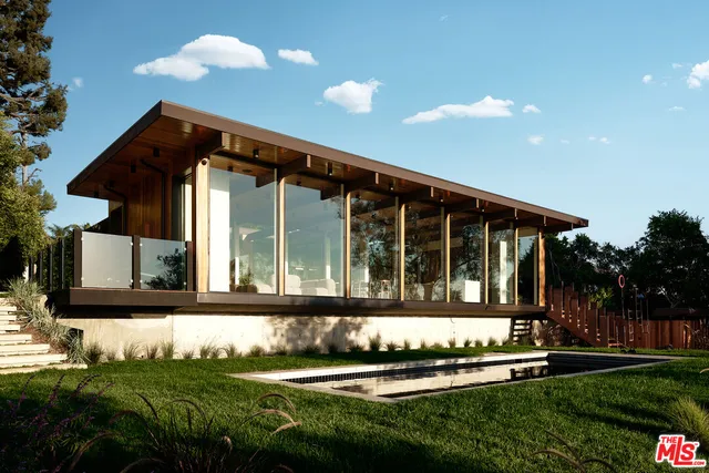 a front view of a house with a yard table and chairs