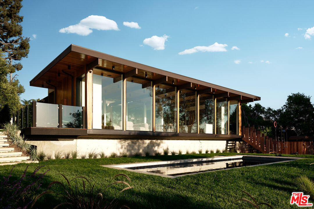 5637 Busch Drive Malibu, CA 90265 - Photo 17 of 27 a front view of a house with a yard table and chairs
