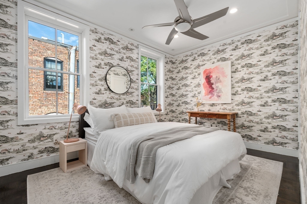 35 Hanson Street, Unit 2 Boston, MA 02118 - Photo 12 of 23 a bedroom with a bed and a window with wall paintings