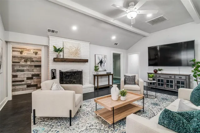 a living room with fireplace furniture and a flat screen tv