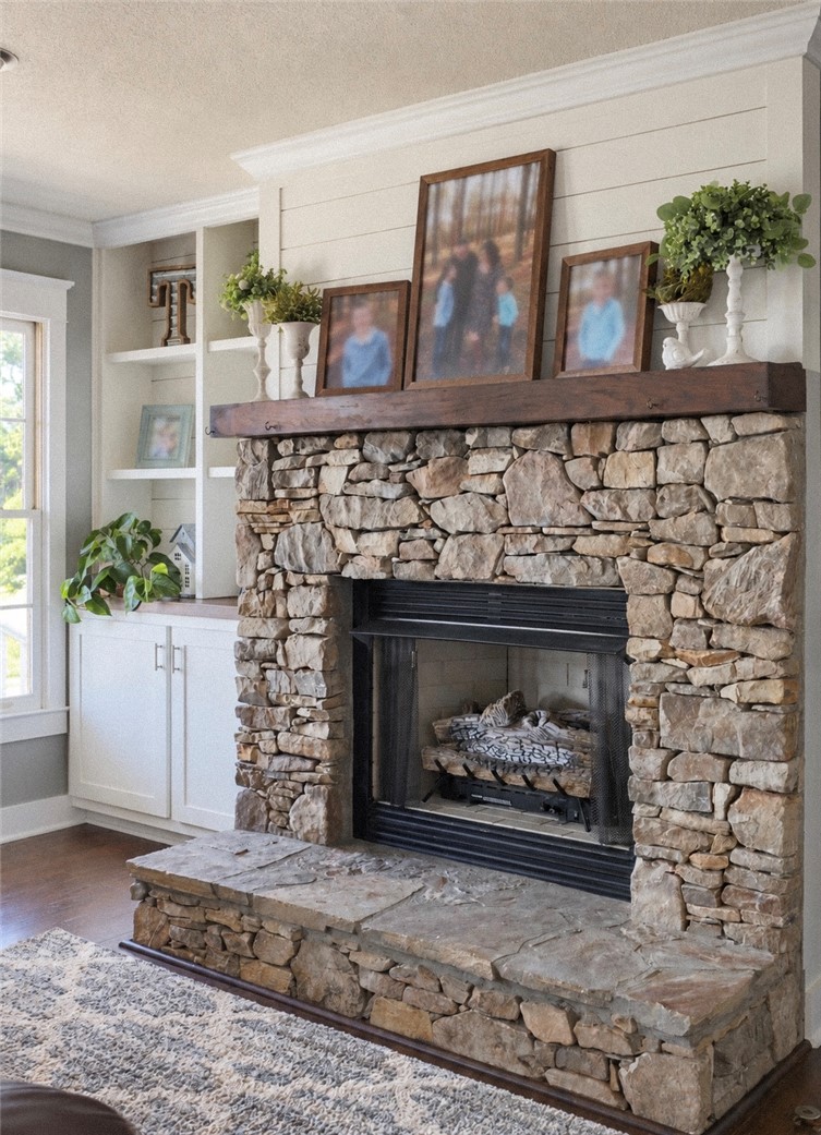 2420 Rainey Road Starr, SC 29684 - Photo 9 of 36 An impressive stone fireplace with a thick wood mantel anchors this inviting living space.