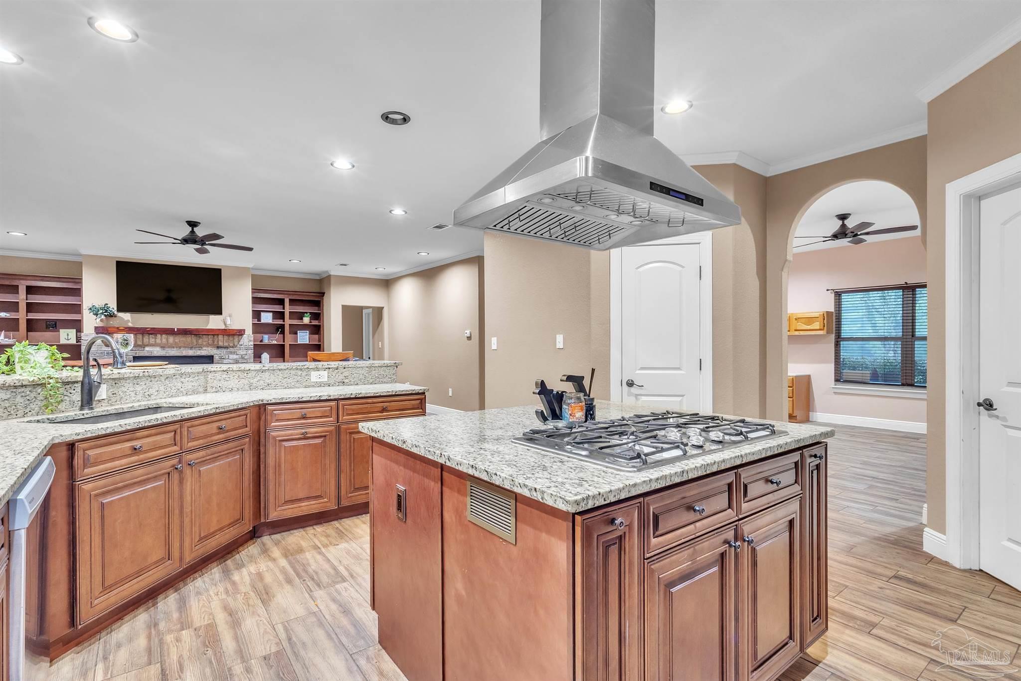 5406 Steele Road Baker, FL 32531 - Photo 13 of 46 a kitchen with granite countertop kitchen island sink stove and wooden floor