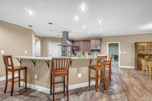 a dining room with furniture and wooden floor