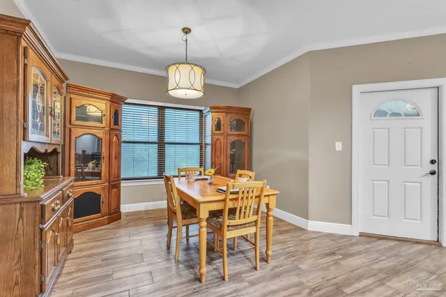 a view of a dining room with furniture wooden floor and chandelier