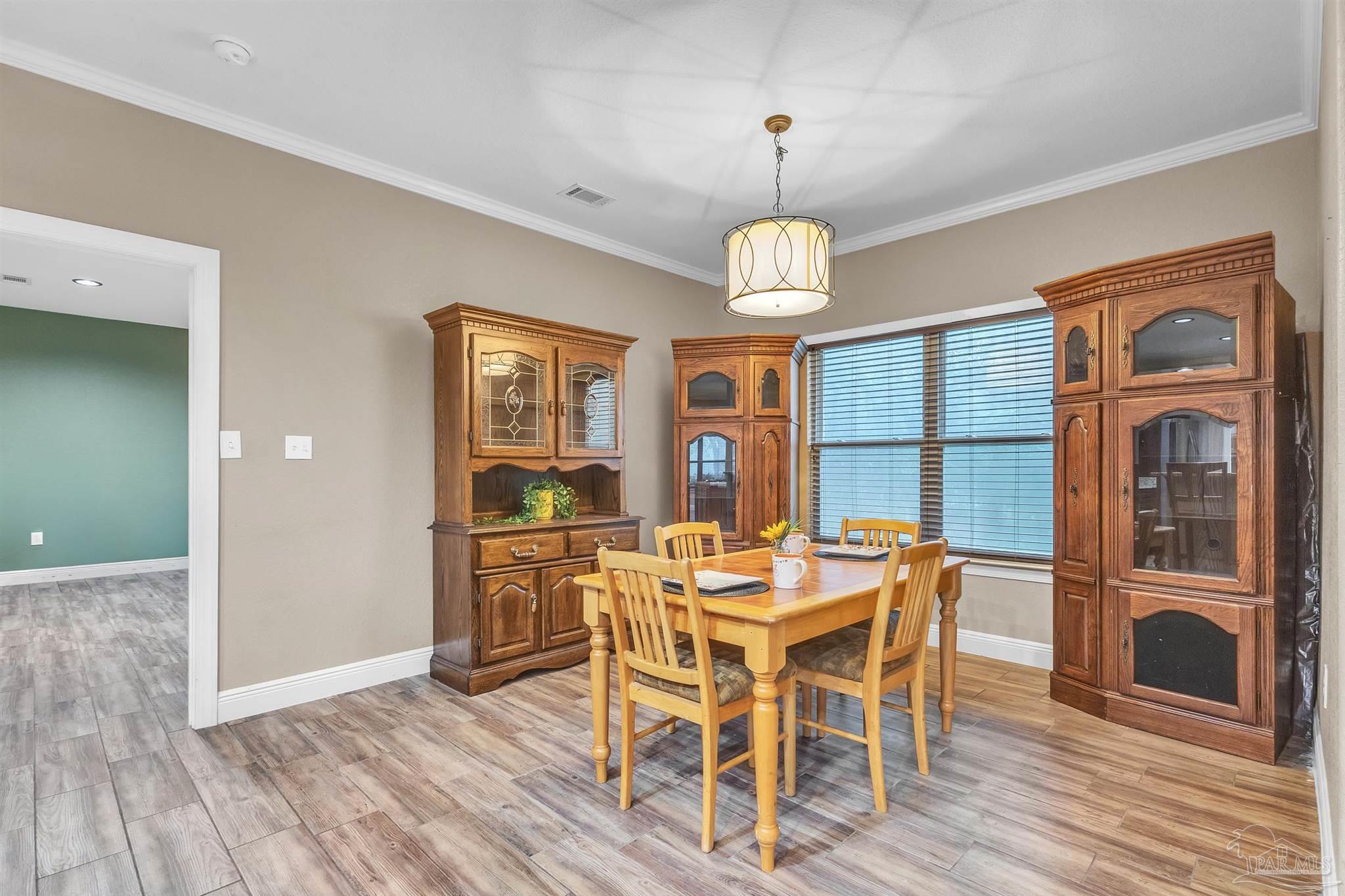 5406 Steele Road Baker, FL 32531 - Photo 18 of 46 a view of a dining room with furniture window and wooden floor