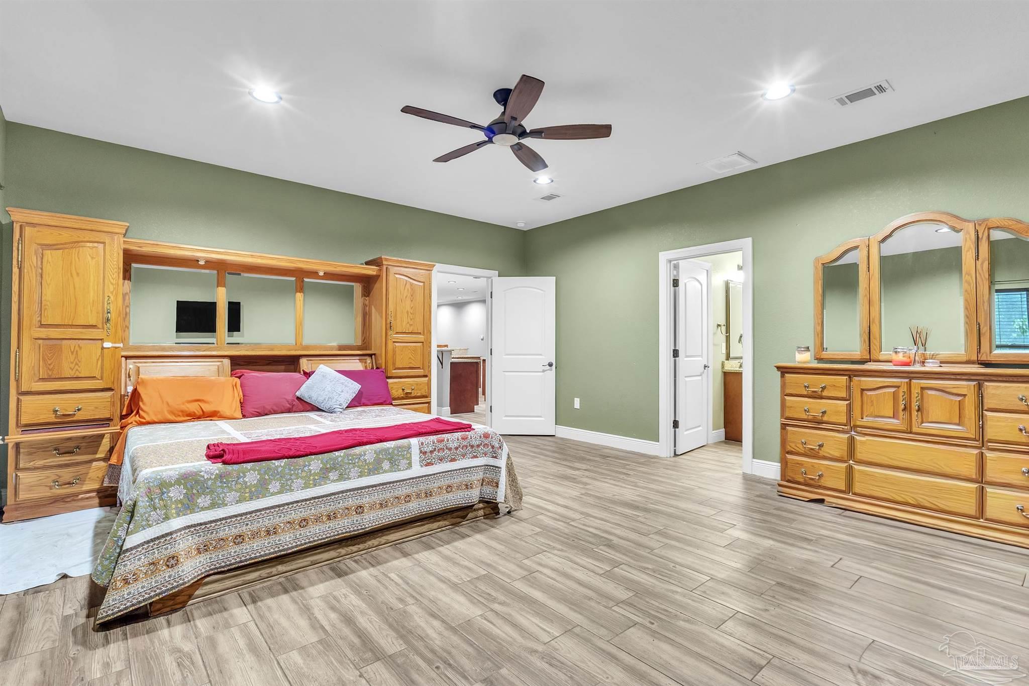 5406 Steele Road Baker, FL 32531 - Photo 19 of 46 a bedroom with a bed and wooden floor