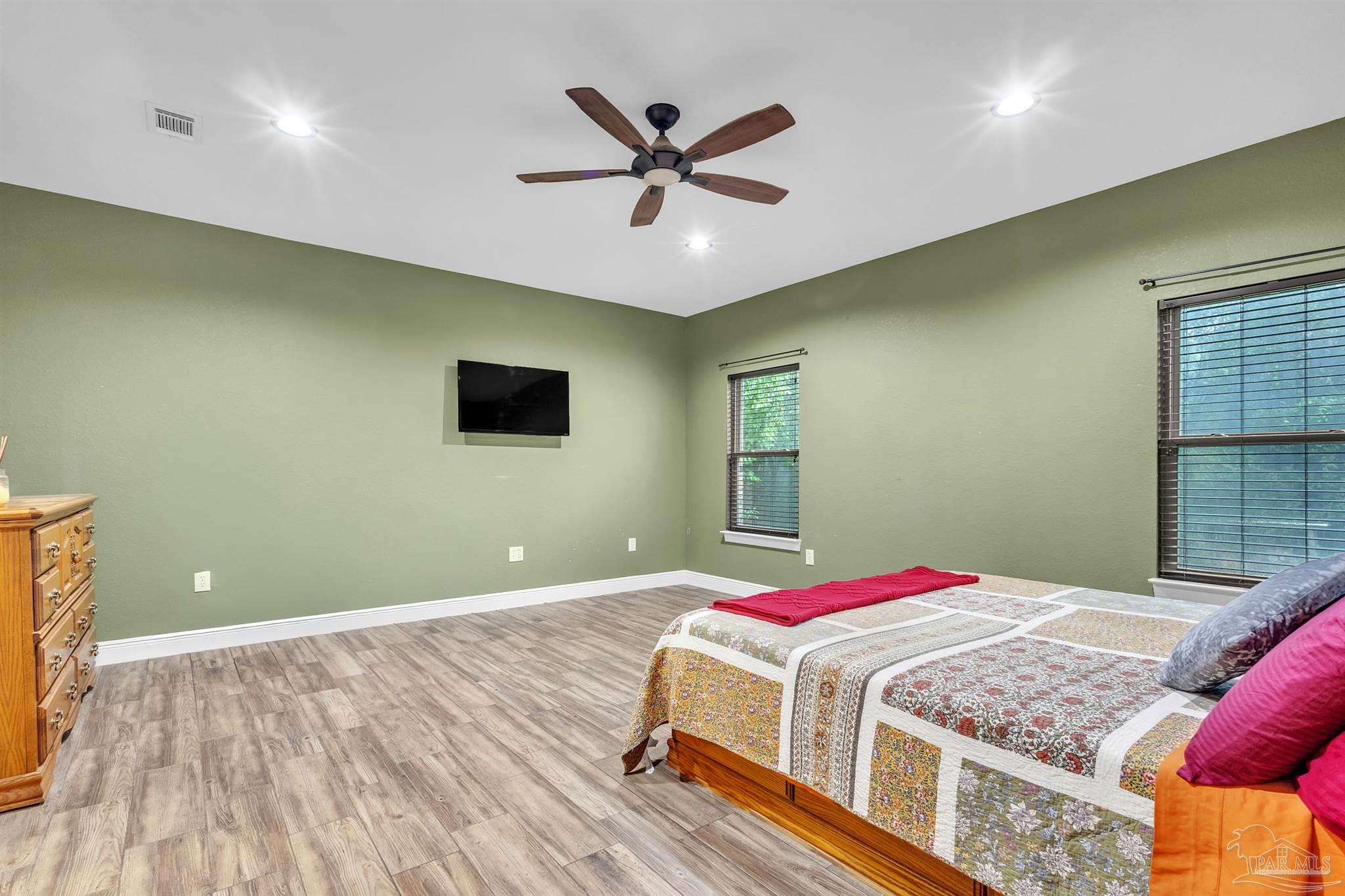 5406 Steele Road Baker, FL 32531 - Photo 20 of 46 a bedroom with a bed and a ceiling fan