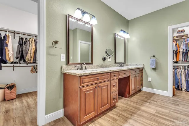 a bathroom with a double vanity sink and a mirror