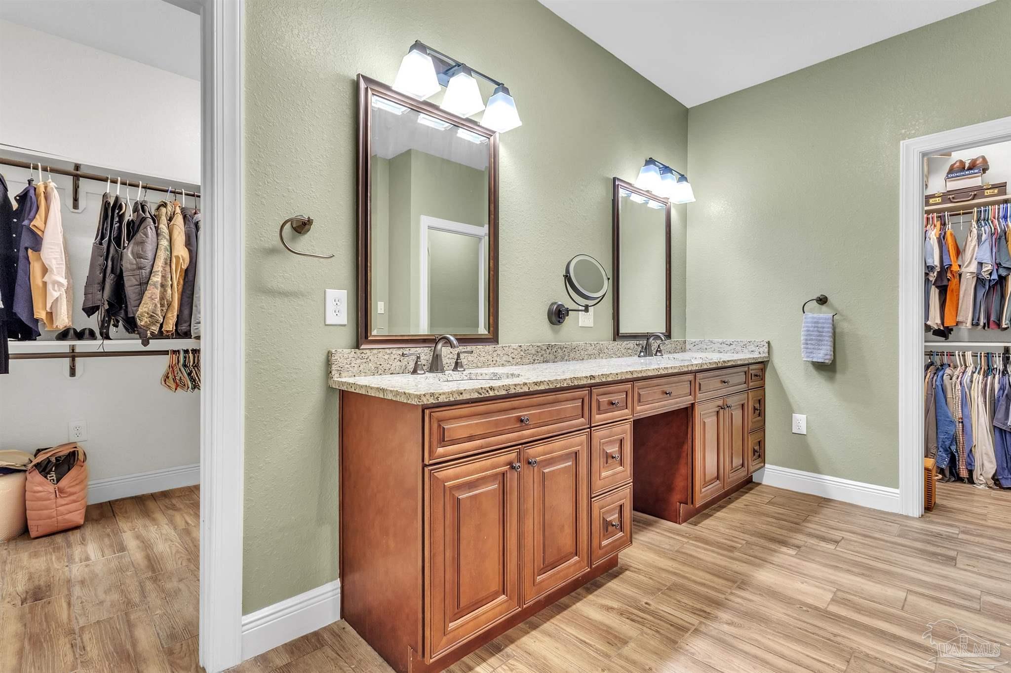 5406 Steele Road Baker, FL 32531 - Photo 22 of 46 a bathroom with a double vanity sink and a mirror