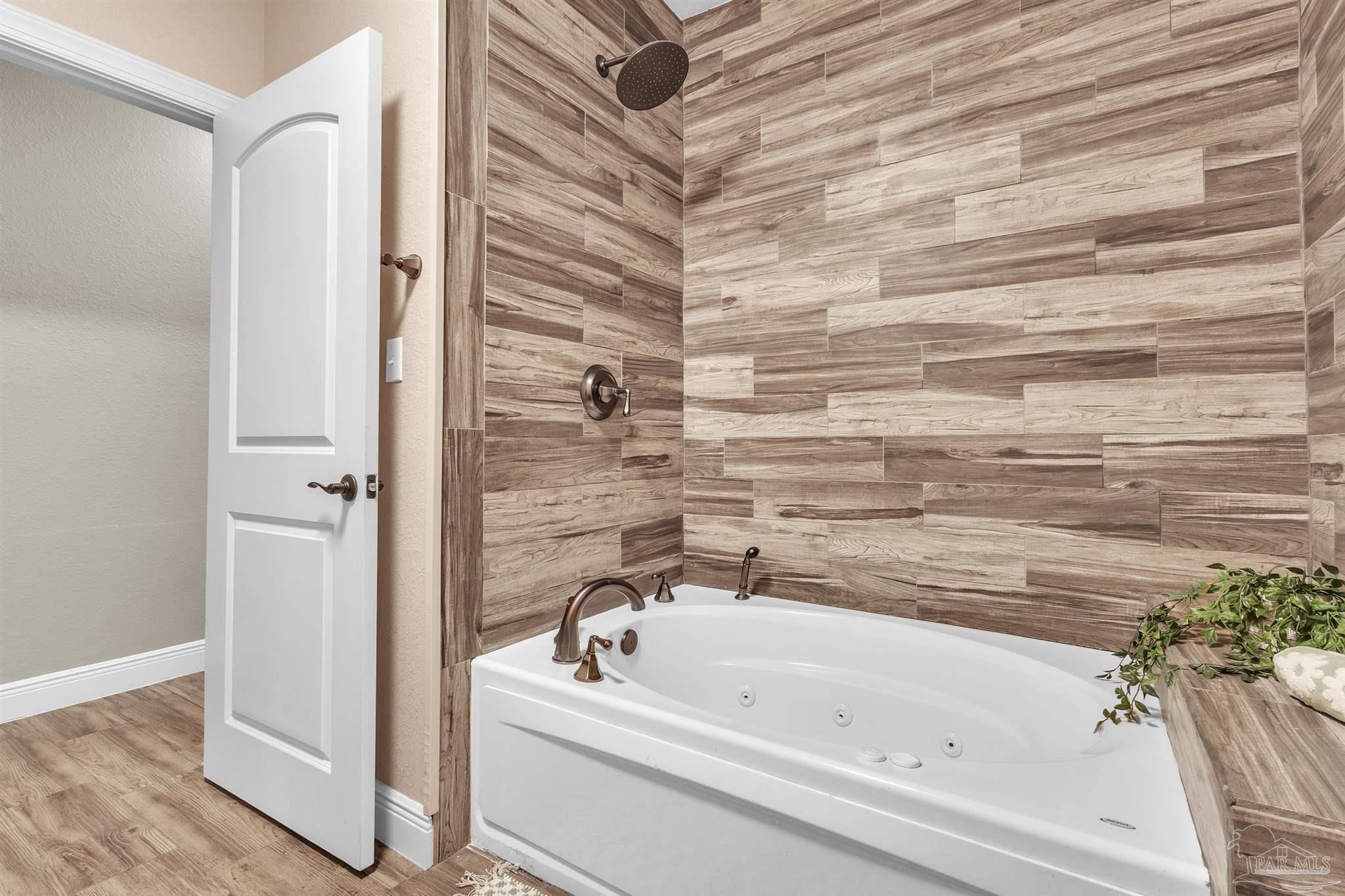 5406 Steele Road Baker, FL 32531 - Photo 29 of 46 a bathroom with a bathtub and a shower