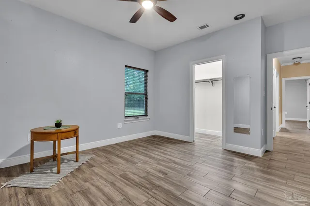 wooden floor in an empty room with a window