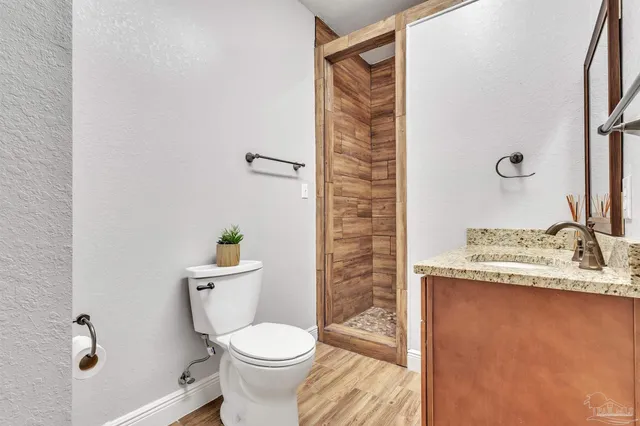a white toilet sitting next to a bathroom sink