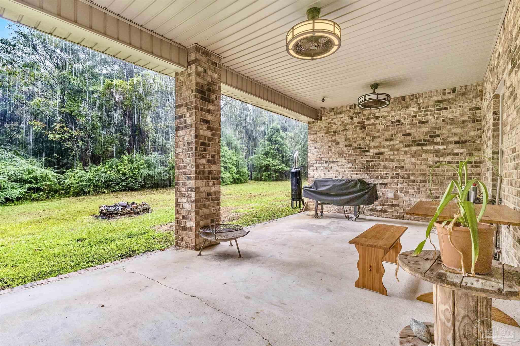 5406 Steele Road Baker, FL 32531 - Photo 35 of 46 a view of a porch with chairs and backyard