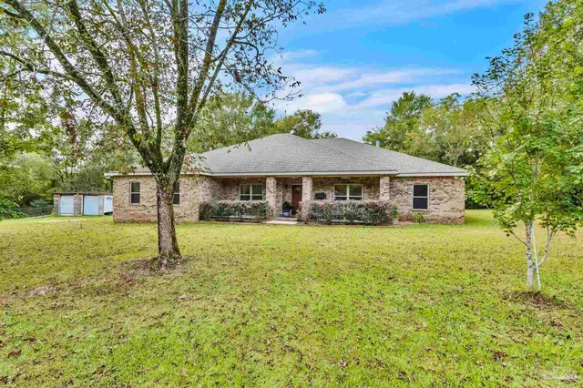 a view of multiple houses with yard