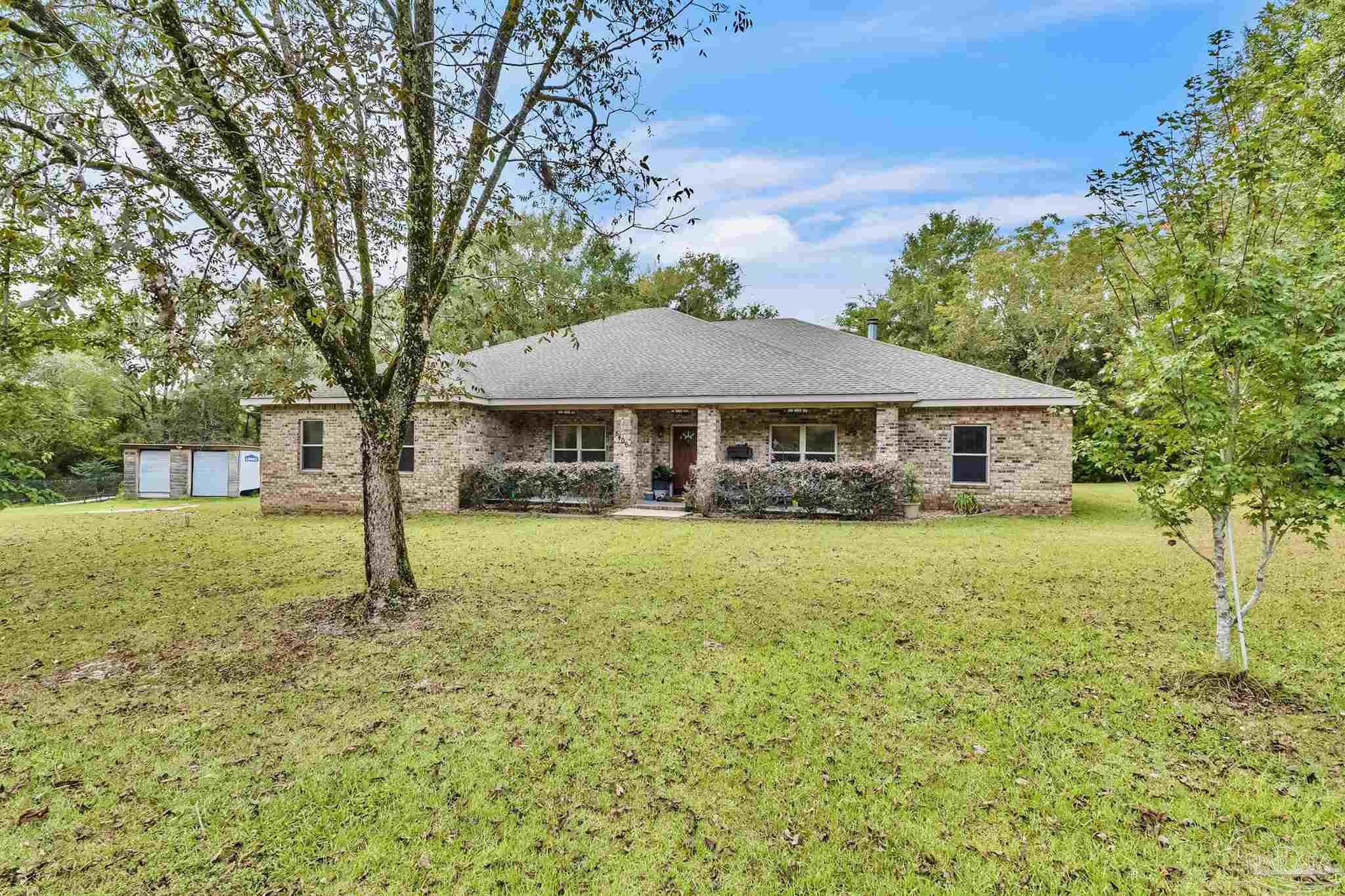 5406 Steele Road Baker, FL 32531 - Photo 39 of 46 a house with swimming pool in front of it