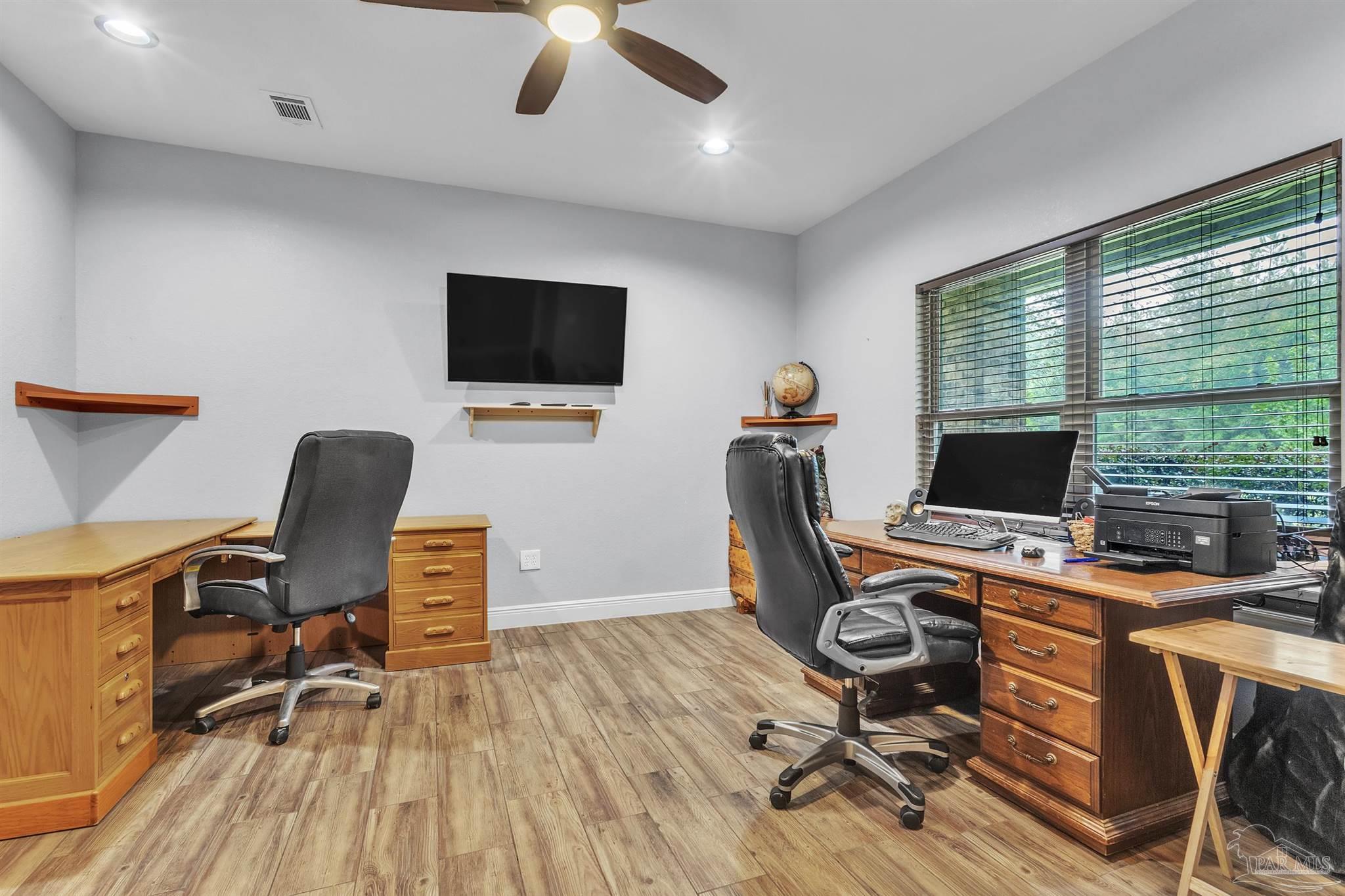5406 Steele Road Baker, FL 32531 - Photo 5 of 46 a view of a workspace with furniture and a window