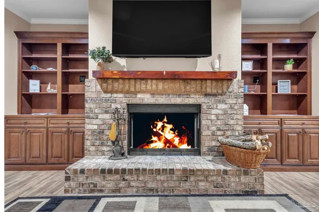 a living room with a fireplace and a flat screen tv