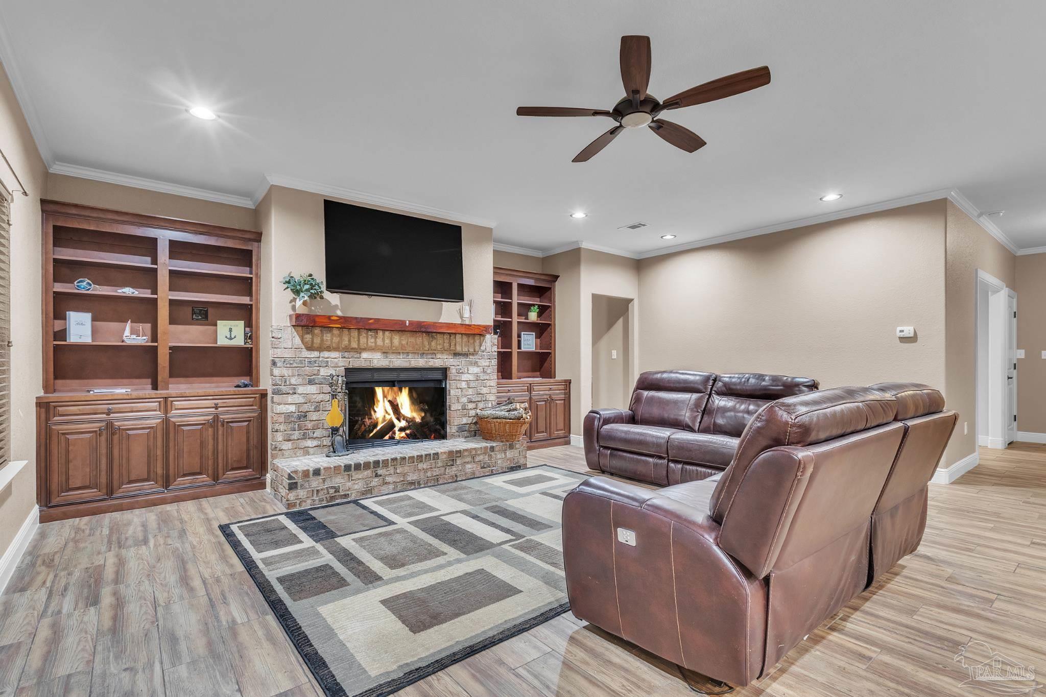 5406 Steele Road Baker, FL 32531 - Photo 8 of 46 a living room with furniture a flat screen tv and a fireplace