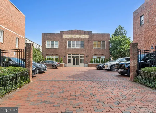 a view of a brick building next to a yard