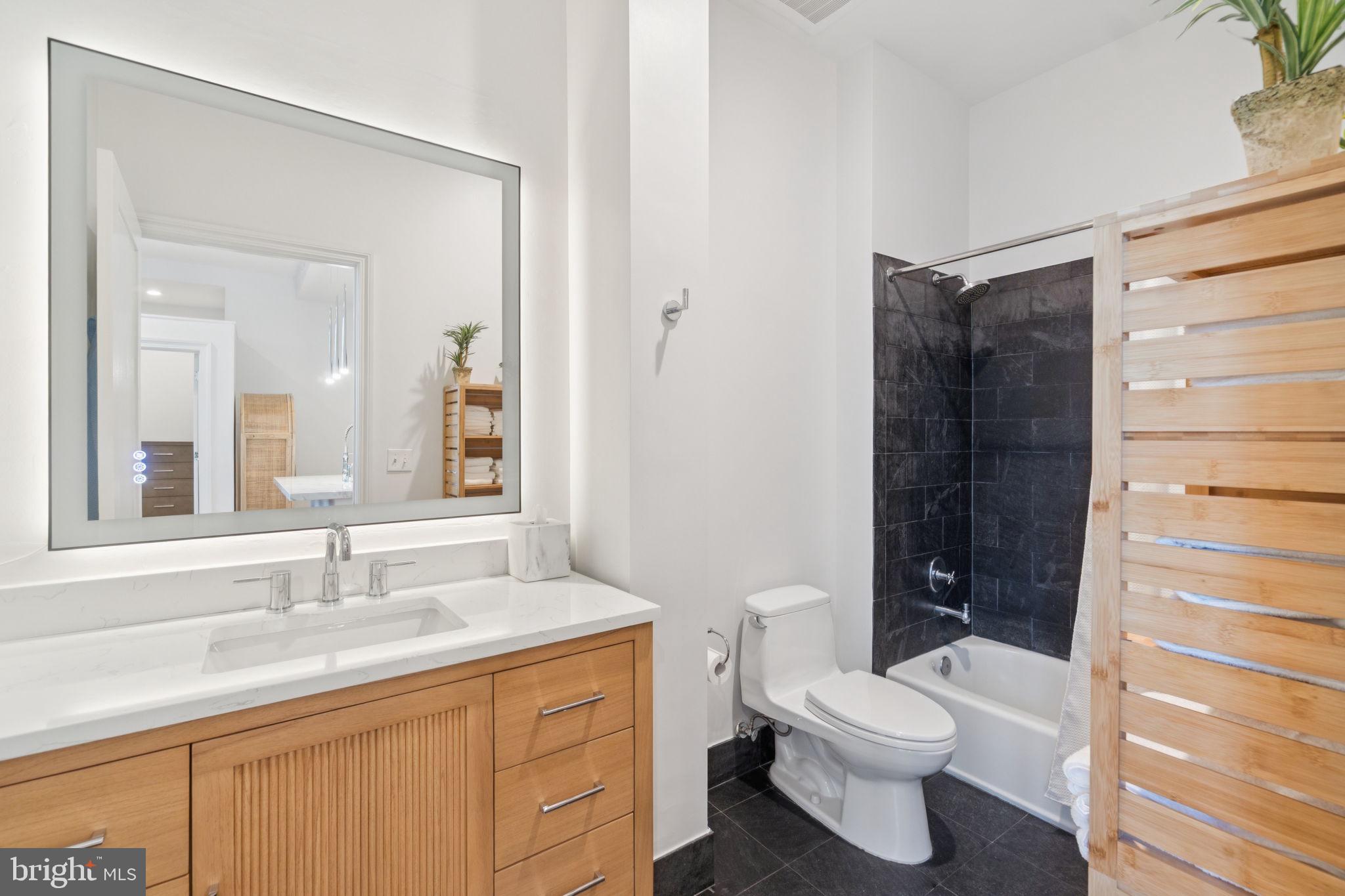 2516 Q Street Northwest, Unit Q206 Washington, DC 20007 - Photo 12 of 16 a bathroom with a granite countertop sink toilet and shower