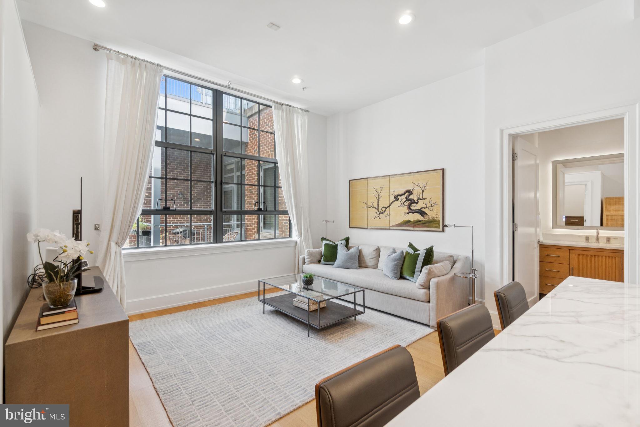 2516 Q Street Northwest, Unit Q206 Washington, DC 20007 - Photo 2 of 16 a living room with furniture and a large window