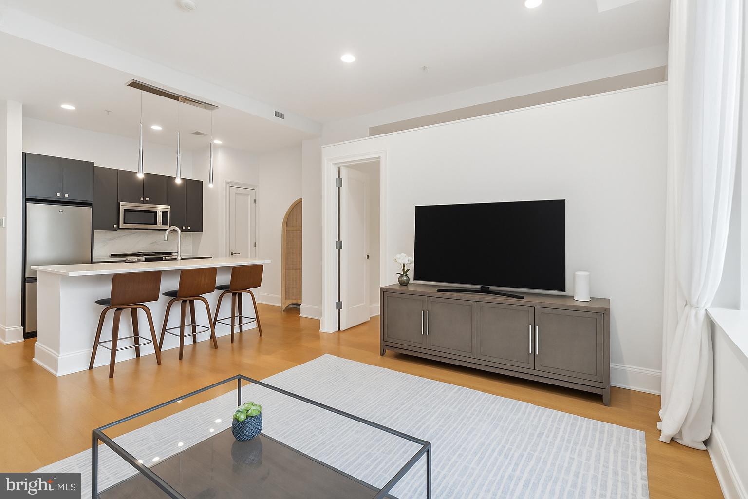 2516 Q Street Northwest, Unit Q206 Washington, DC 20007 - Photo 8 of 16 a living room with furniture and a flat screen tv