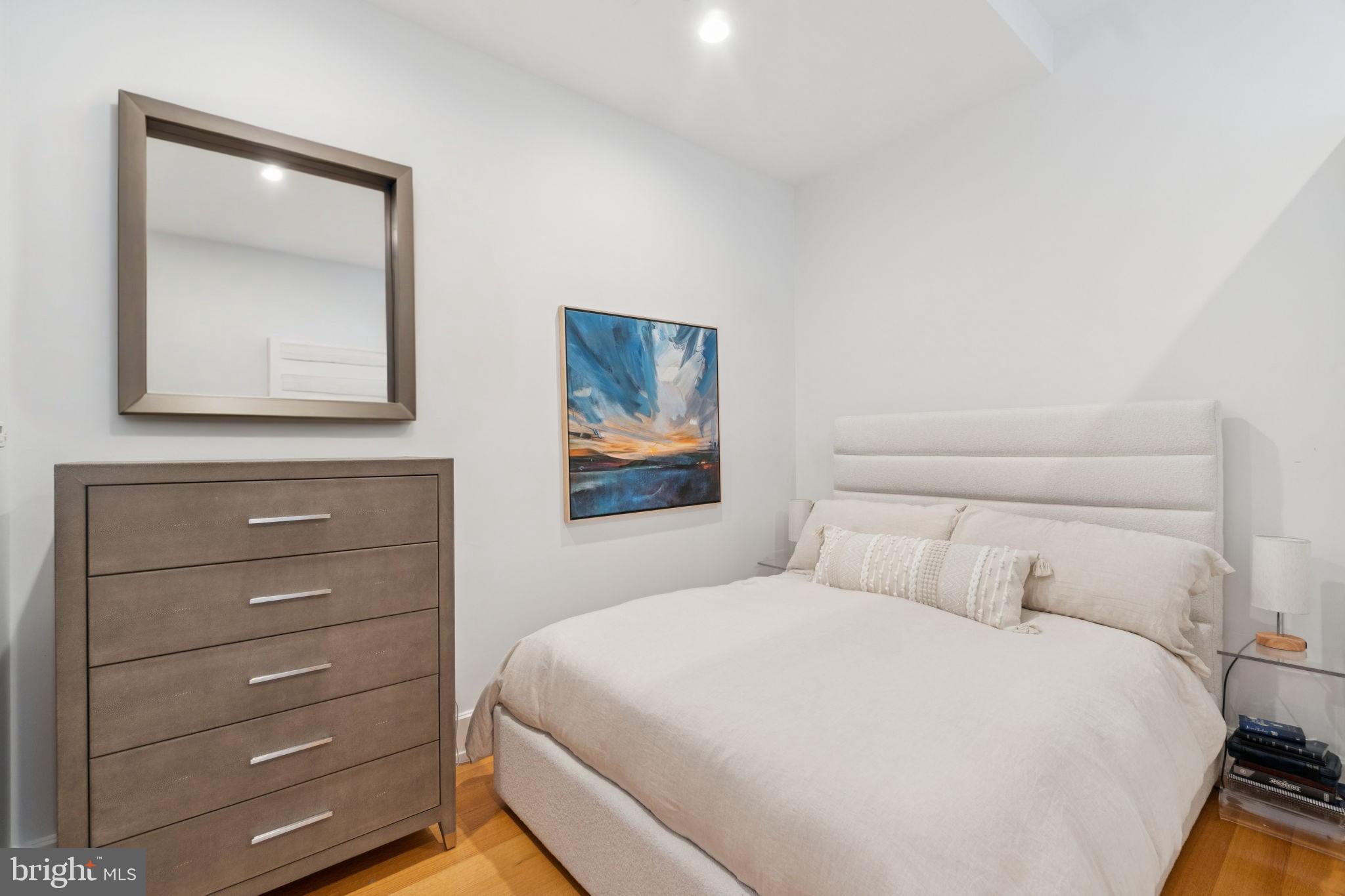 2516 Q Street Northwest, Unit Q206 Washington, DC 20007 - Photo 10 of 16 a bedroom with a bed and a mirror