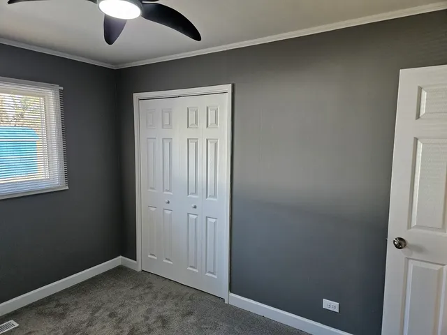 an empty room with windows and closet