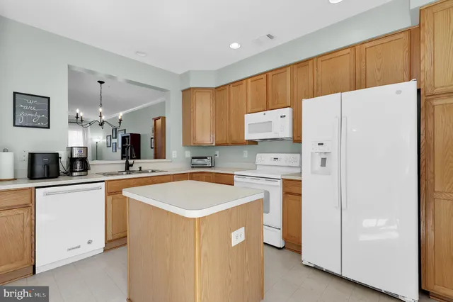 a kitchen with stainless steel appliances a refrigerator sink and cabinets