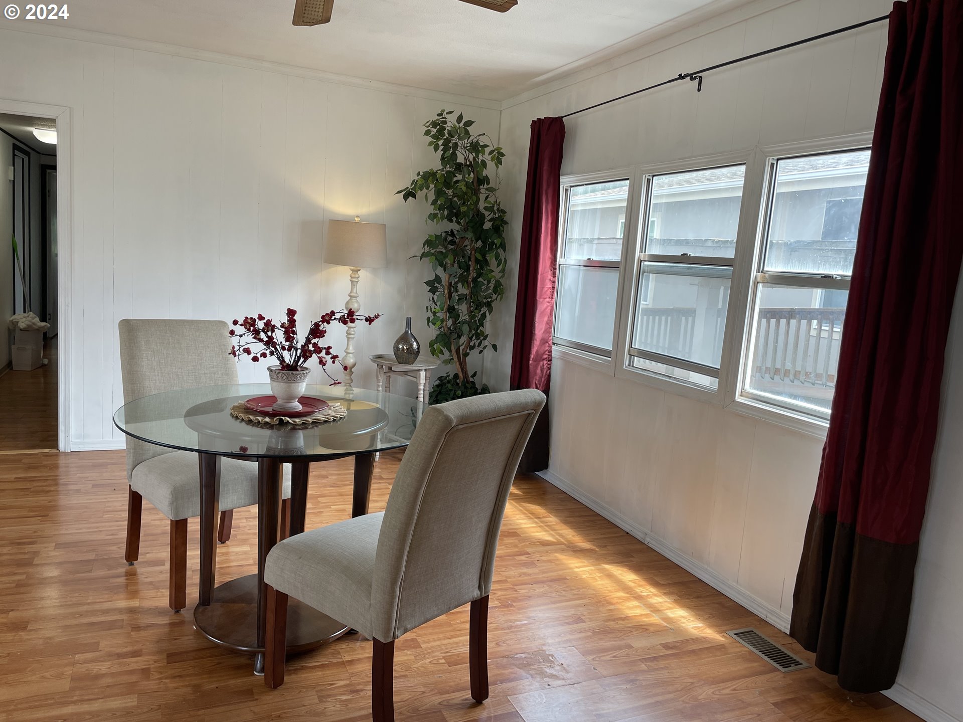 2150 Laura Street, Unit 99 Springfield, OR 97477 - Photo 11 of 24 a view of a dining room with furniture and wooden floor